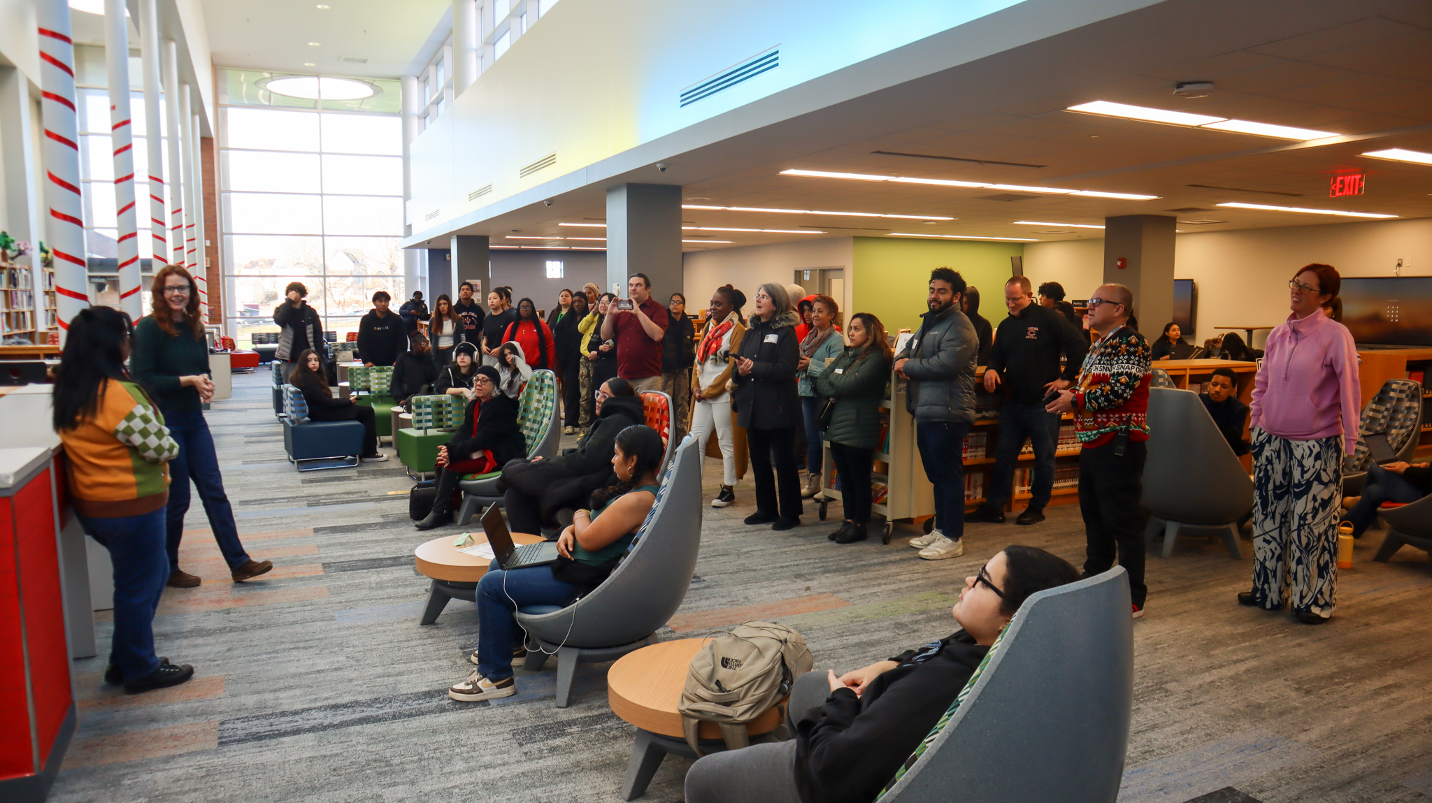 Jasmine (Jay) Velasquez and Ms. Augspurg speaking to those gathered in the CHS Library at the mural unveiling ceremony.